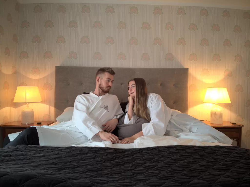 Couple relaxing in a cozy and spacious bed